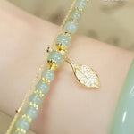 Boucles d'oreilles en rameaux d'or et feuilles de jade