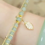 Boucles d'oreilles en rameaux d'or et feuilles de jade