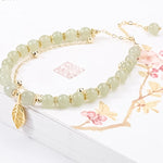Boucles d'oreilles en rameaux d'or et feuilles de jade