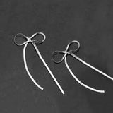 Boucles d'oreilles longues avec nœud