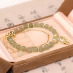 Boucles d'oreilles en rameaux d'or et feuilles de jade