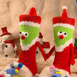 Chaussettes Père Noël tenant la main