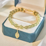 Boucles d'oreilles en rameaux d'or et feuilles de jade