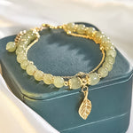 Boucles d'oreilles en rameaux d'or et feuilles de jade