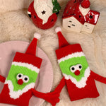 Chaussettes Père Noël tenant la main