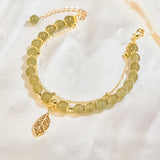 Boucles d'oreilles en rameaux d'or et feuilles de jade