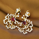 Boucles d'oreilles puces rubis cerclées d'or