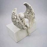 Ornement d'ange tenant une jambe