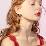 Boucles d'oreilles puces rubis cerclées d'or