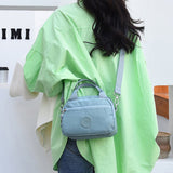 Sac à main fonctionnel à plusieurs compartiments de couleur unie