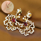 Boucles d'oreilles puces rubis cerclées d'or