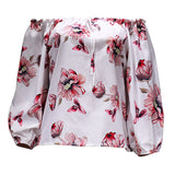 Haut fleuri à épaules dénudées et ourlet volanté