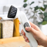 Brosse à pot avec distribution automatique de liquide
