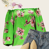 Haut fleuri à épaules dénudées et ourlet volanté