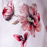 Haut fleuri à épaules dénudées et ourlet volanté