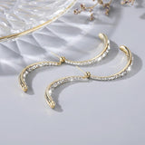 Boucles d'oreilles incurvées en croix à la mode