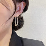 Boucles d'oreilles incurvées en croix à la mode