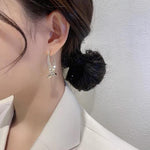 Boucles d'oreilles incurvées en croix à la mode